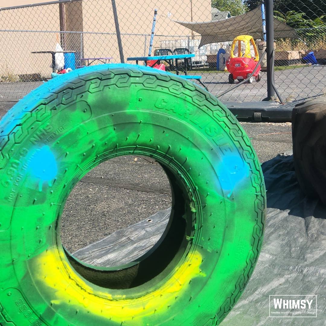 A brightly painted tire prepared for the sensory playground